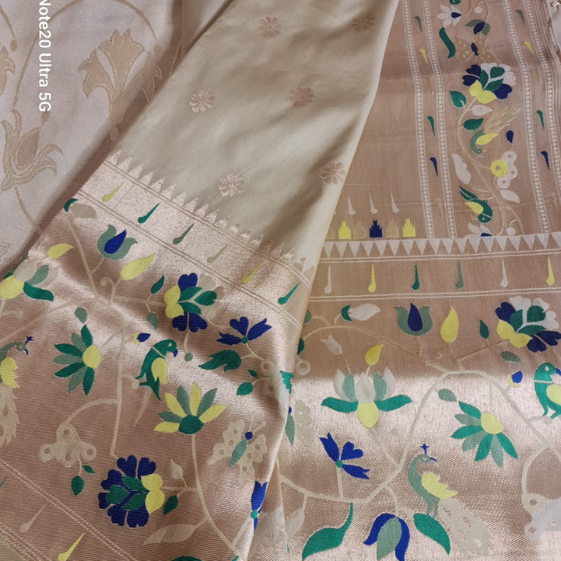 Champagne color Paithani saree with traditional peacock & lotus motifs in gold zari border with tassels