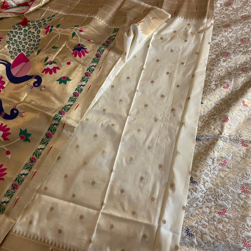 Handwoven Ceam color Paithani saree with traditional colorful peacock and lotus motifs in gold zari border with tassels