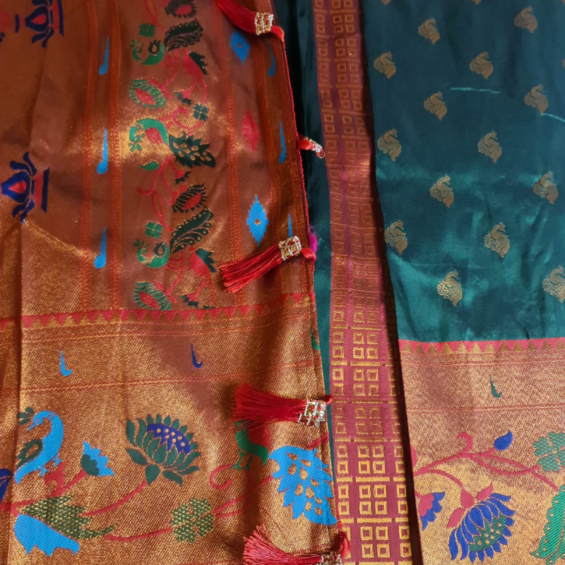 Handwoven Dark Green Paithani saree with traditional colorful peacock and lotus motifs in gold zari border