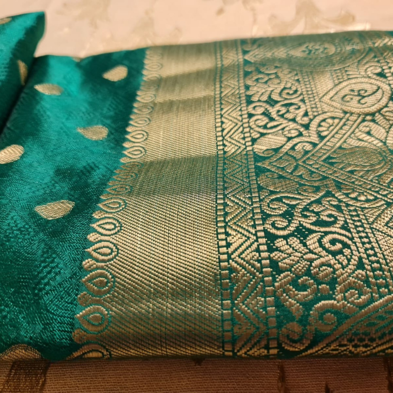 Green Benarasi silk blend saree with intricate gold zari detailing & motifs