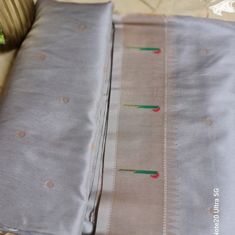 Grey Paithani saree with traditional peacock & lotus motifs in gold zari border with tassels