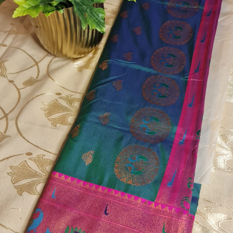 Handwoven Paithani saree with traditional colorful peacock and lotus motifs in gold brocade border