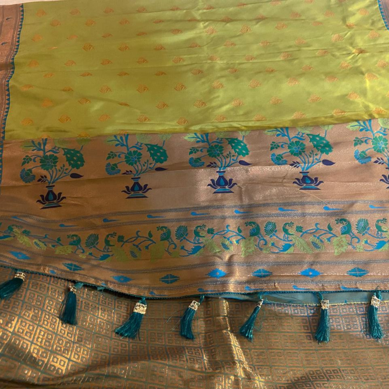 Handwoven Lime Green Paithani saree with traditional colorful peacock and lotus motifs in gold zari border