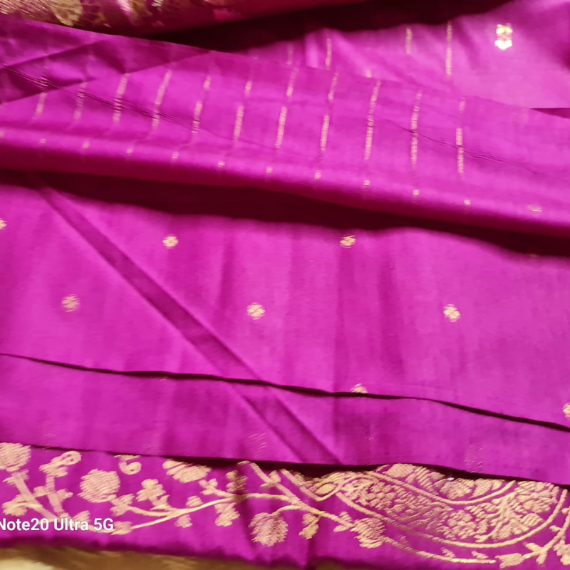 Magenta Benarasi saree with intricate gold zari detailing with tassels