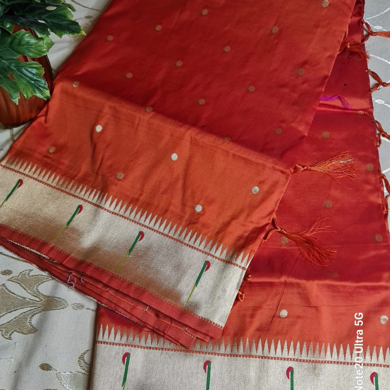 Orange Paithani saree with traditional peacock & lotus motifs in gold zari border with tassels