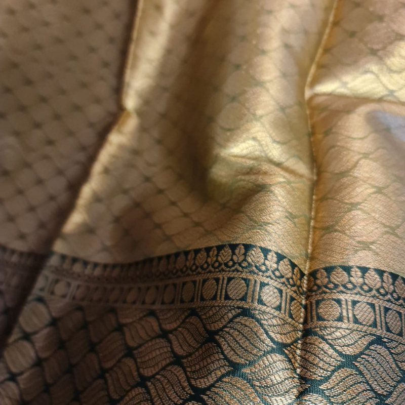 Intricately woven Gold Organza Saree with Dark Green Brocade Border – Elegant Drape