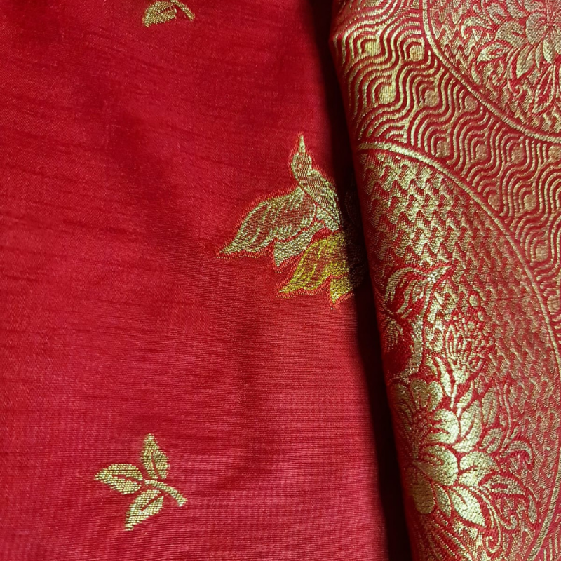 Red Benarasi saree with intricate gold zari detailing with tassels