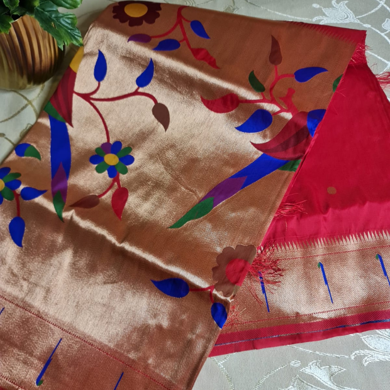 Red Paithani saree with traditional peacock & lotus motifs in gold zari border with tassels