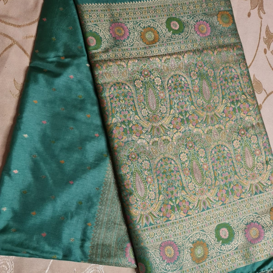 Teal Benarasi saree with intricate gold zari detailing with tassels