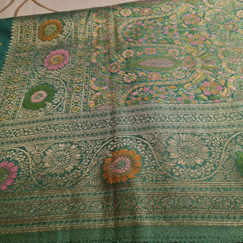 Teal Benarasi saree with intricate gold zari detailing with tassels