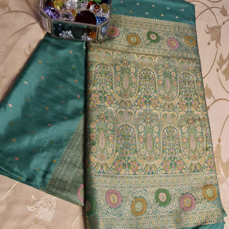 Teal Benarasi saree with intricate gold zari detailing with tassels