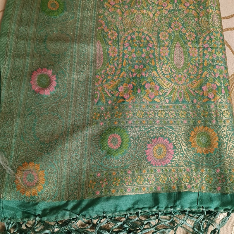 Teal Benarasi saree with intricate gold zari detailing with tassels