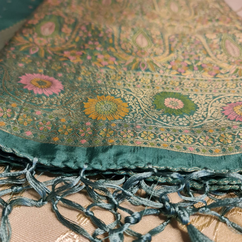 Teal Benarasi saree with intricate gold zari detailing with tassels