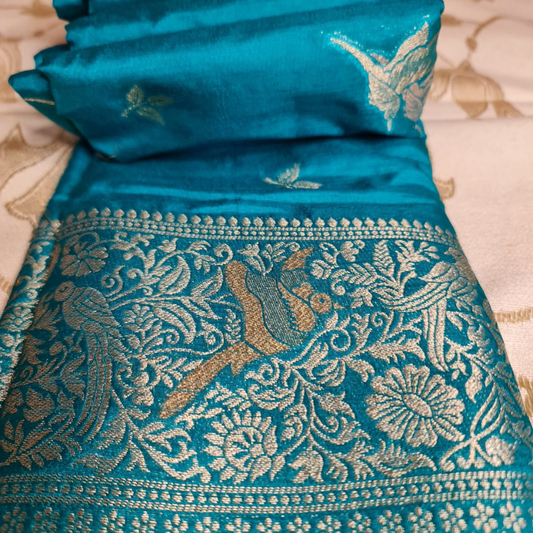 Teal Green Benarasi saree with intricate gold zari detailing with tassels