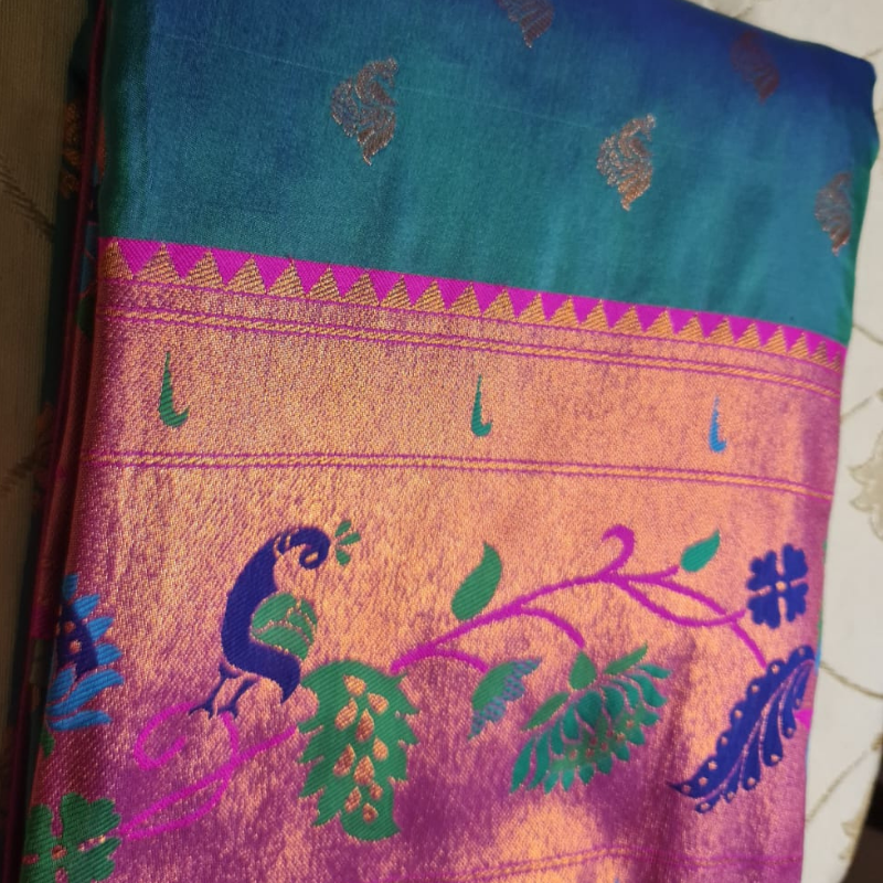Handwoven Paithani saree with traditional colorful peacock and lotus motifs in gold brocade border
