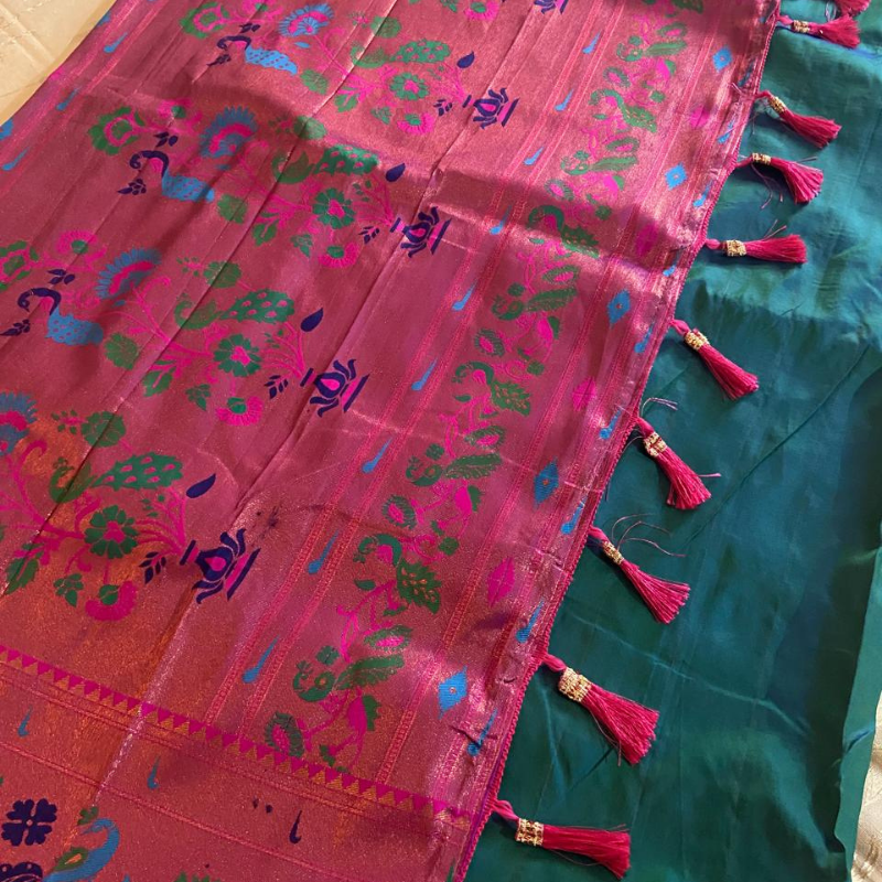 Handwoven Paithani saree with traditional colorful peacock and lotus motifs in gold brocade border