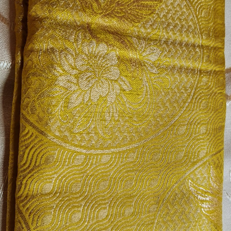 Yellow Benarasi saree with intricate gold zari detailing with tassels