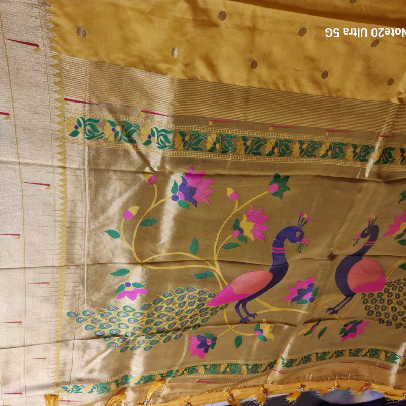 Handwoven Yellow color Paithani saree with traditional colorful peacock and lotus motifs in gold zari border with tassels