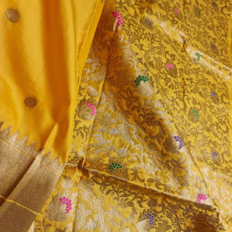 Handwoven Yellow color Paithani saree with traditional colorful peacock and lotus motifs in gold zari border with tassels
