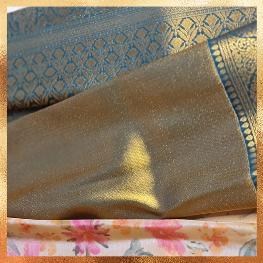 Bridal Kanjivaram golden hue dual tone saree with datk green boder & golden zari. Perfect for weddings & festive wear. Handpicked collection at The Saree Mahal