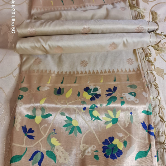 Champagne color Paithani saree with traditional peacock & lotus motifs in gold zari border with tassels