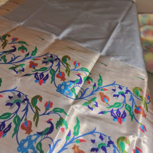 Grey Paithani saree with traditional peacock & lotus motifs in gold zari border with tassels