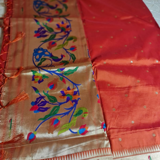 Orange Paithani saree with traditional peacock & lotus motifs in gold zari border with tassels