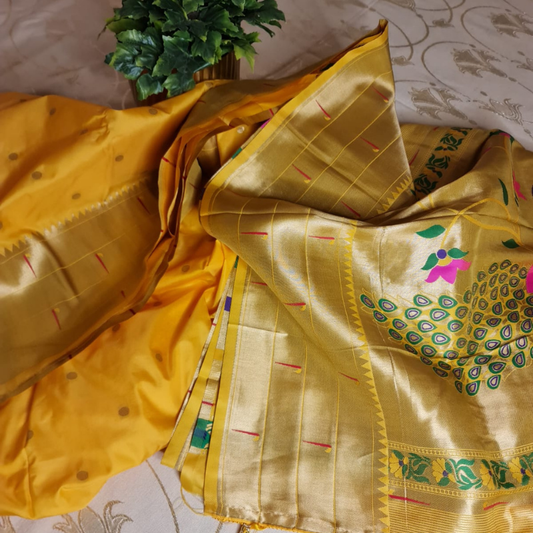 Handwoven Yellow color Paithani saree with traditional colorful peacock and lotus motifs in gold zari border with tassels